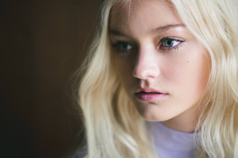 Girl with blonde hair and clumpy mascara