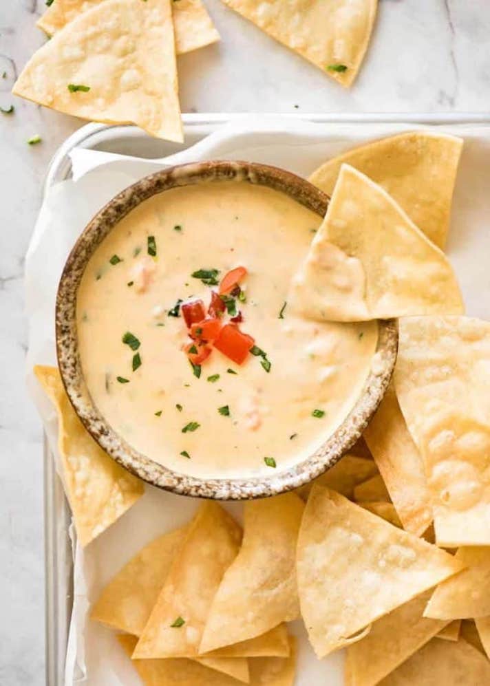 STYLECASTER | 17 Halloween Dips You Can Serve In A Pumpkin | Queso Cheese Dip