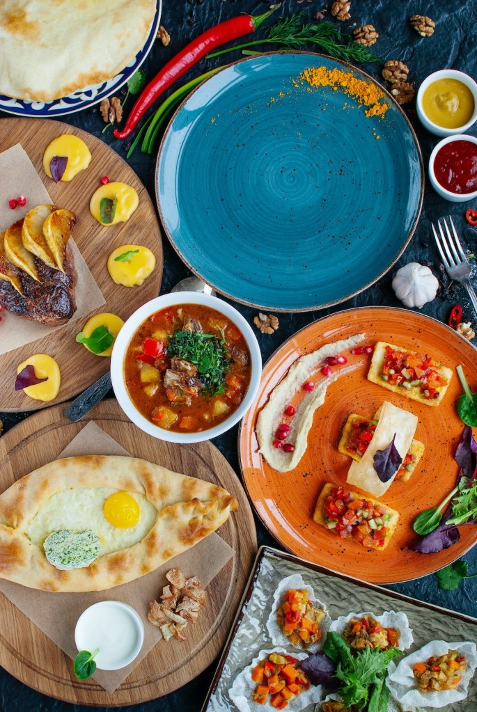 A table topped with colorful plates holding different dishes
