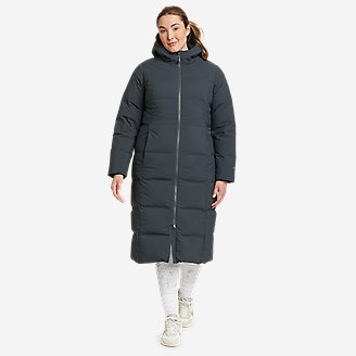A model wearing the Eddie Bauer Women's Glacier Peak Seamless Stretch Down Duffle Coat in black