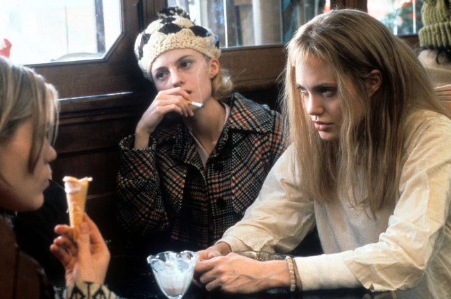 Angelina Jolie sits with Clea DuVall (left) and another girl in a scene from the film 'Girl, Interrupted', 1999.