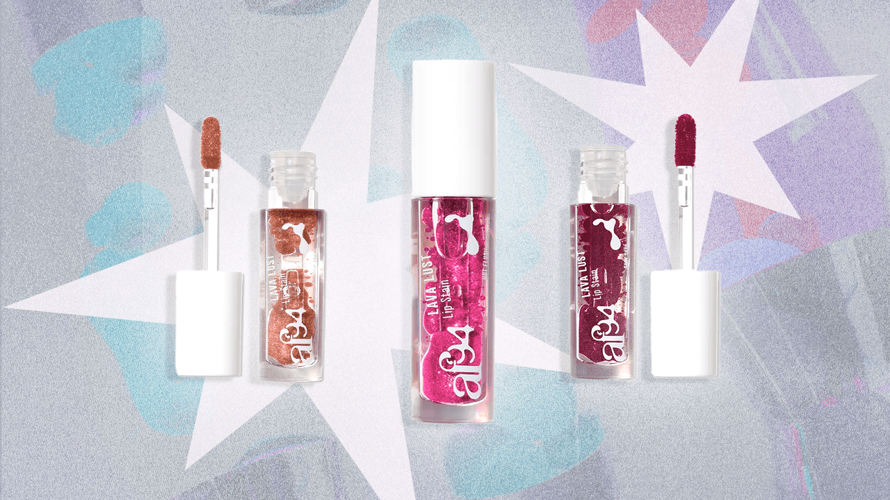 Af94 Lava Lust Lip Stains in Slip Dress a peachy color, Hot Flush a hot pink, and Baby Says a deep berry. They are in clear bottles and resemble a lava lamp, in front of white stars and lava lamps in the background.