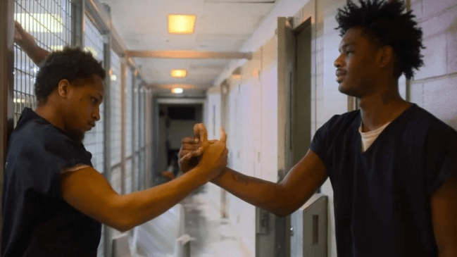 Inmate Mason Abraham shakes hands with another inmate in Netflix's Unlocked: A Jail Experiment 