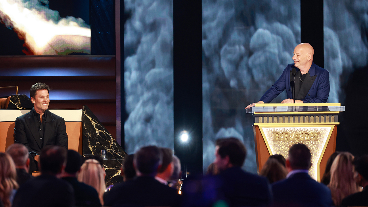 INGLEWOOD, CALIFORNIA - MAY 05: (L-R) Tom Brady and Jeff Ross speak onstage during G.R.O.A.T The Greatest Roast Of All Time: Tom Brady for the Netflix is a Joke Festival at The Kia Forum on May 05, 2024 in Inglewood, California.