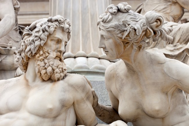 A male and female Greek statue looking at each other