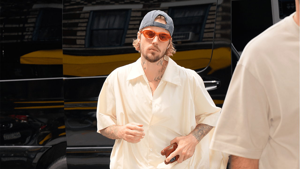 Justin Bieber wearing orange sunglasses.