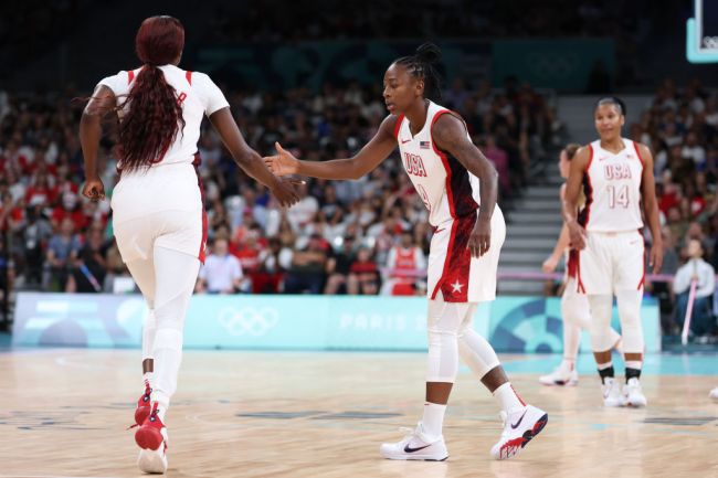 Chelsea Gray #8 of Team United States high fives a teammate during the Women's Group Phase - Group C game between Japan and United States on day three of the Olympic Games Paris 2024 at Stade Pierre Mauroy on July 29, 2024 in Lille, France.