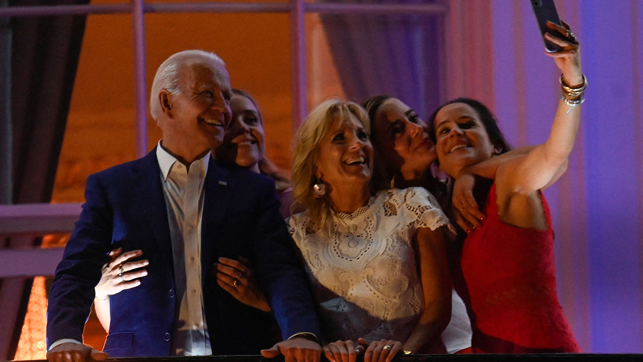 US President Joe Biden (L), First Lady Jill Biden (C), daughter Ashley Biden (R) and granddaughters Finnegan Biden (2nd L) and Naomi Biden pose for a selfie during Independence Day celebrations at the White House in Washington, DC, July 4, 2021.