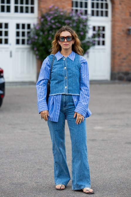 Masha Sedgwick wears striped button shirt, jeans, top outside Baum & Pferdgarten during day three of the Copenhagen Fashion Week (CPHFW) SS25 on August 07, 2024 in Copenhagen, Denmark.