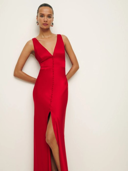 A woman wearing a long red dress