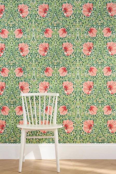 A green wallpaper print with pink flowers.