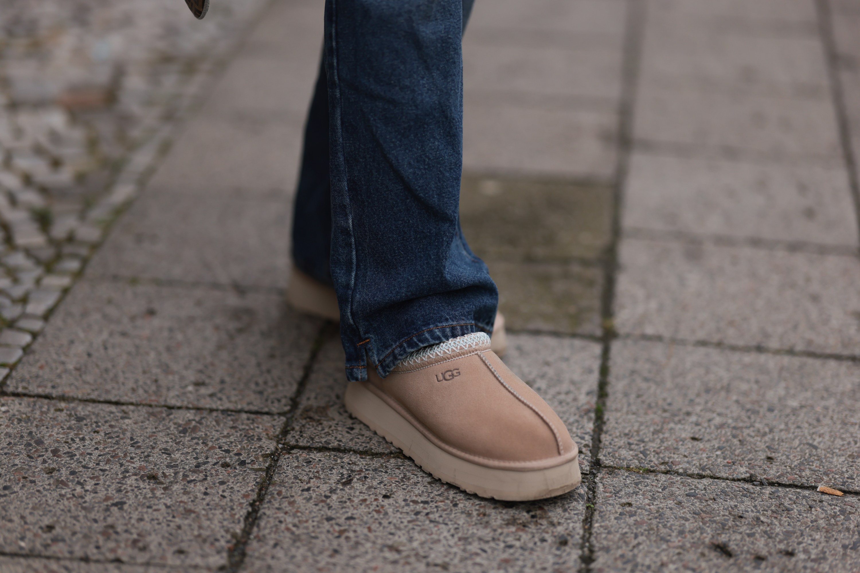 Sophia Geiss is seen wearing straight-legged jeans with orange decorative seams from Worst Behavior, and sand-colored platform shoes from Ugg on September 26, 2024 in Berlin, Germany.