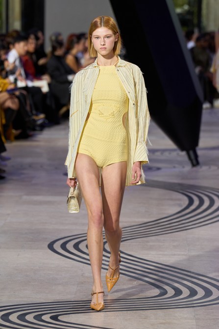 A model wearing a butter yellow outfit.