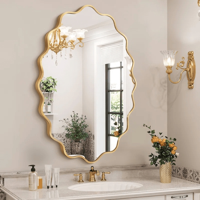 An irregularly-shaped mirror with a golden frame