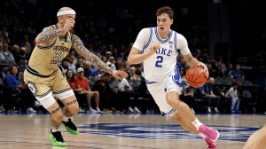 CHARLOTTE, NORTH CAROLINA - MARCH 13: Cooper Flagg #2 of the Duke Blue Devils drives with the ball against Duncan Powell #31 of the Georgia Tech Yellow Jackets during the first half in a quarterfinal game of the ACC men's basketball tournament at Spectrum Center on March 13, 2025 in Charlotte, North Carolina.