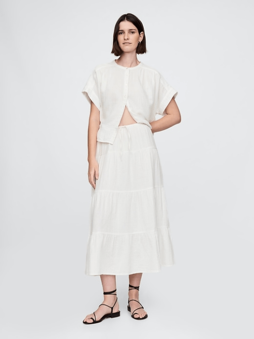 A model wearing the GAP Crinkle Gauze Tiered Maxi Skirt in white
