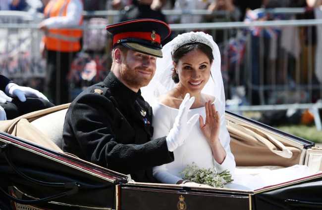 WINDSOR, ENGLAND - MAY 19: (EDITORS NOTE: Retransmission of #960087582 with alternate crop.) Prince Harry, Duke of Sussex and Meghan, Duchess of Sussex wave from the Ascot Landau Carriage during their carriage procession on Castle Hill outside Windsor Castle in Windsor, on May 19, 2018 after their wedding ceremony.