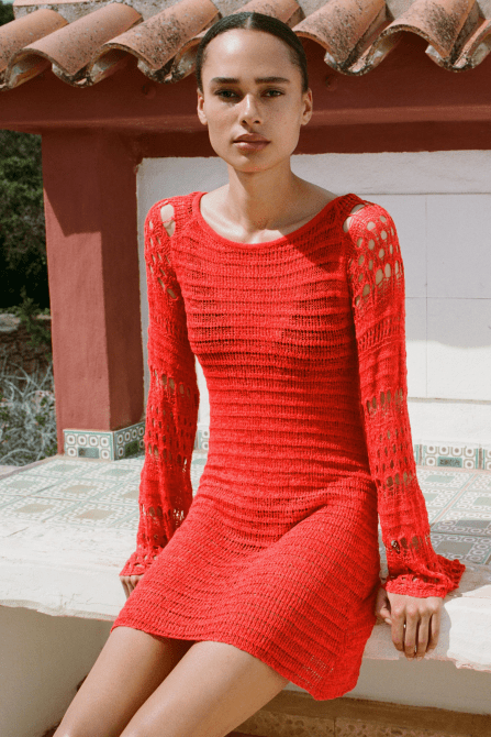 A modelw wearing the Crochet Knit Mini Dress in bright red