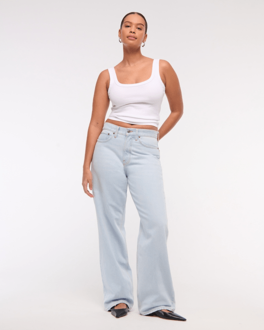 A model wearing Abercrombie & Fitch's Curve Love Mid Rise Slouchy Jean in a light wash